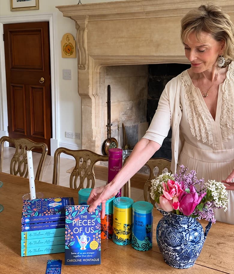 Caroline Montague arranging copies of The Pieces of Us beside flowers